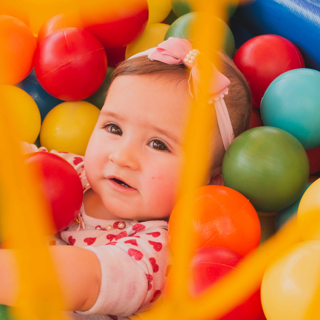 baby playing in a ball pit