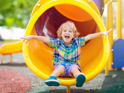young boy playing on a slide