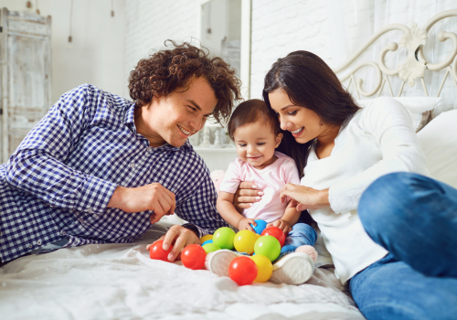 Two parents playing with their baby