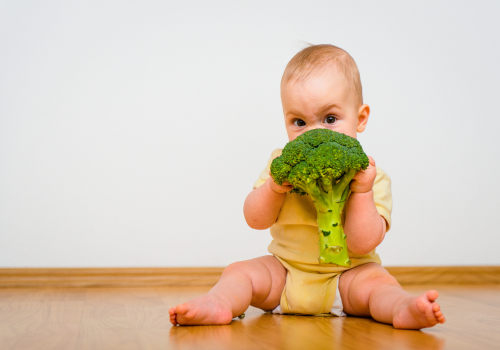 baby eating broccoli