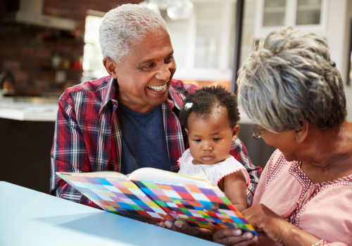 baby and grandparents reading