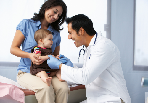 baby getting examined by a doctor