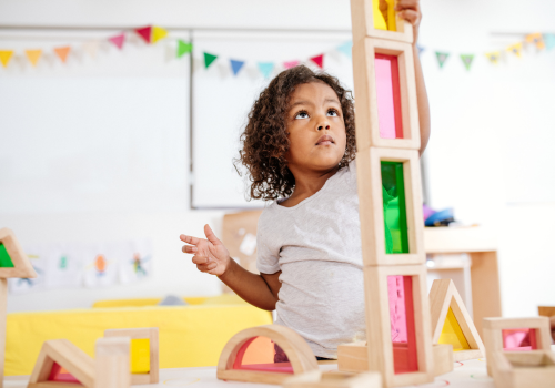 Little girl stacking blocks