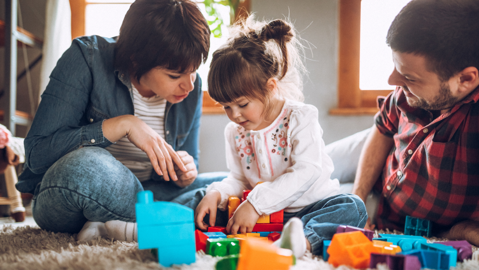 Parents and child playing with toys 