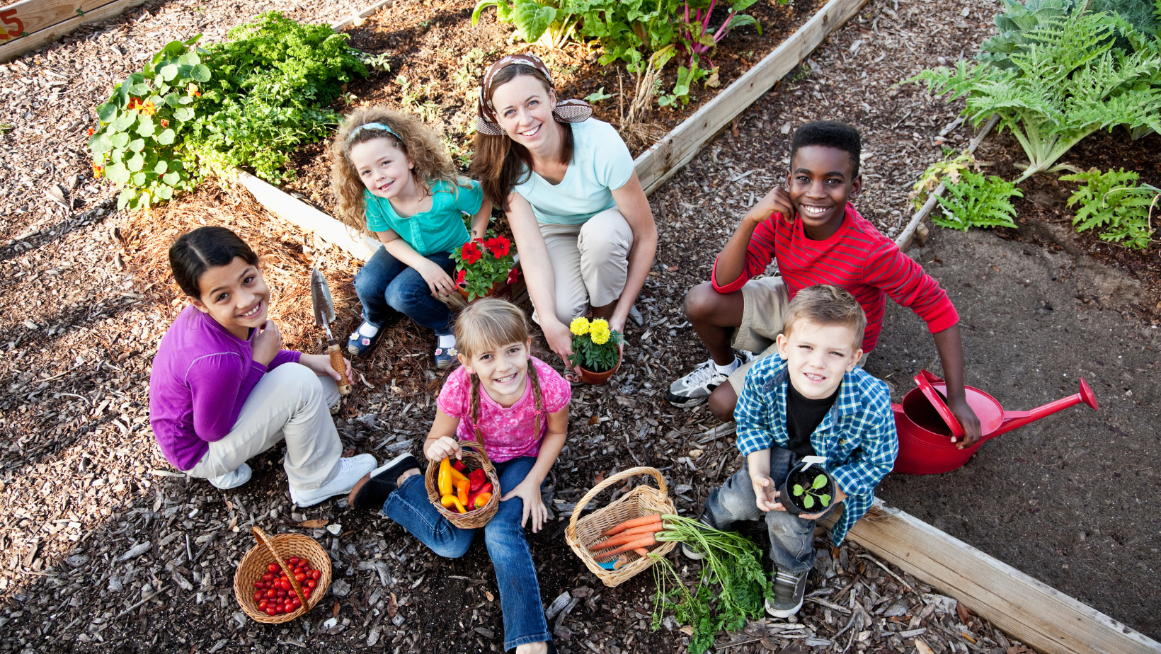 adult and children working in a garden 