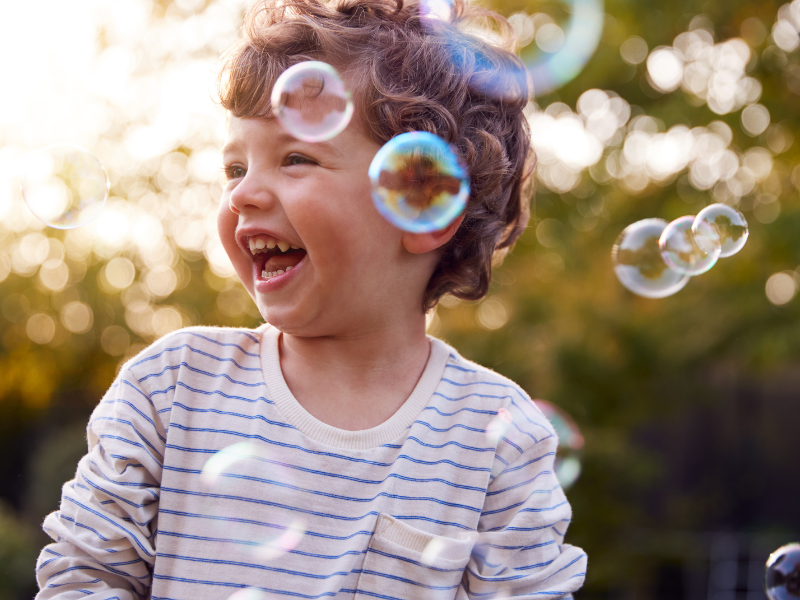 Little boy playing with bubbles