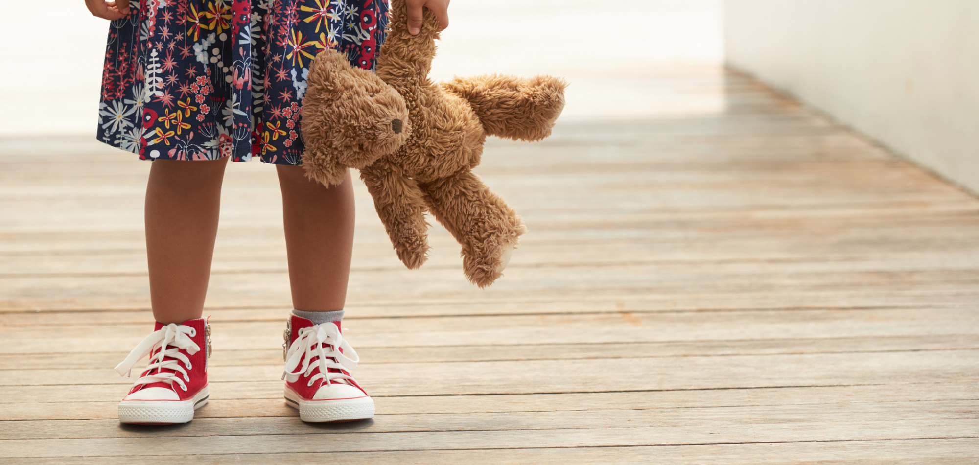 child holding teddy bear