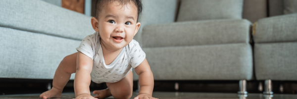 young child crawling on the ground, developmental milestones concept