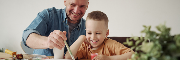 Dad and young child on floor playing