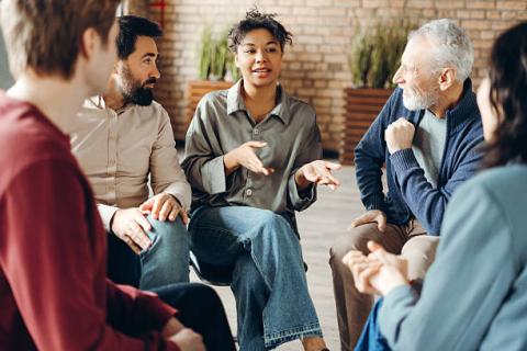 group sitting at a table having a conversation