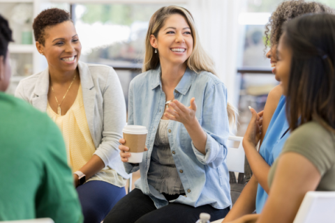 group sitting at a table having a conversation