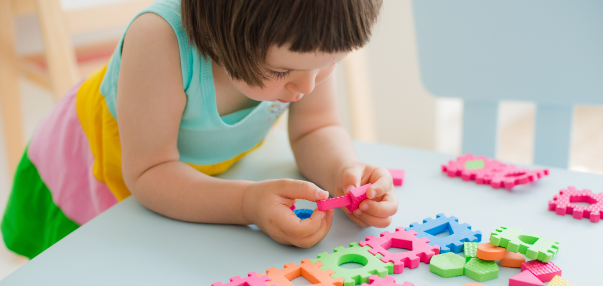 child playing with puzzle